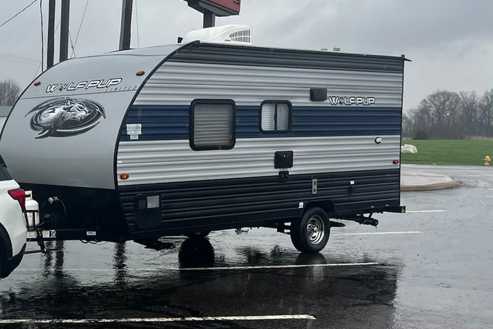 and overhead AC unit.|This RV rental interior features a cozy bedroom with a patterned bed