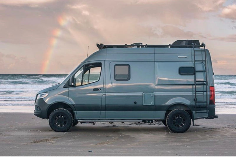  an ideal rv rental for exploring rugged landscapes. Parked on asphalt against a dramatic mountain.|Spacious rv rental interior featuring a lime green kitchenette — photo 2