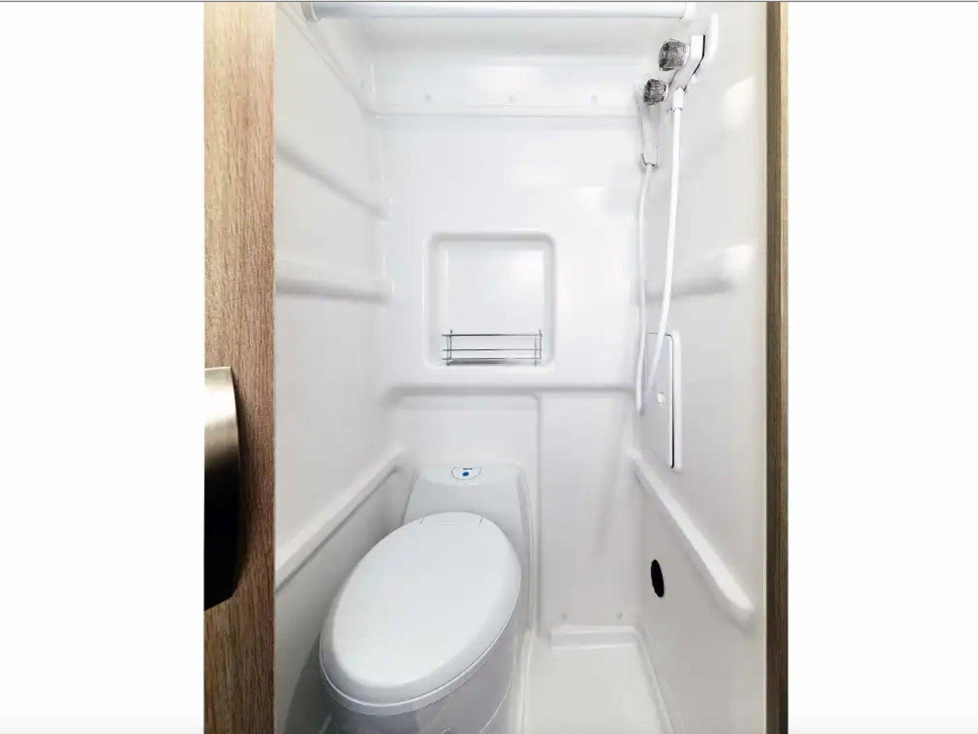 This compact RV rental wet bath features a toilet and an integrated shower with a handheld showerhead, all in white.