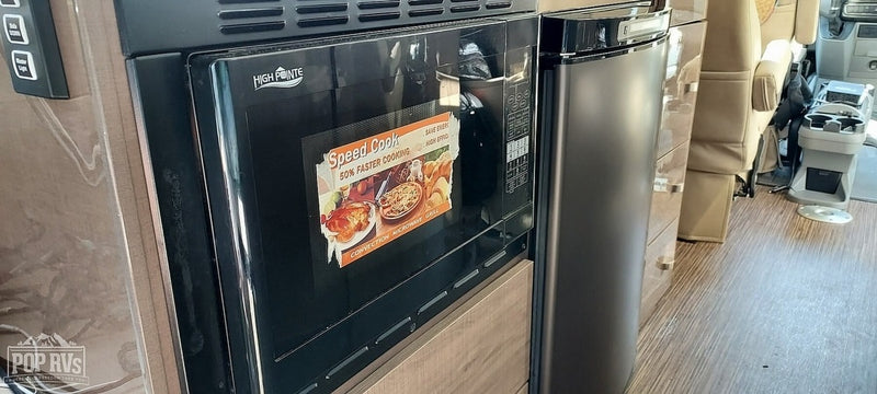 This RV rental features a High Pointe Speed Cook microwave and a compact refrigerator, perfect for efficient cooking and storage on your travels. — photo 8