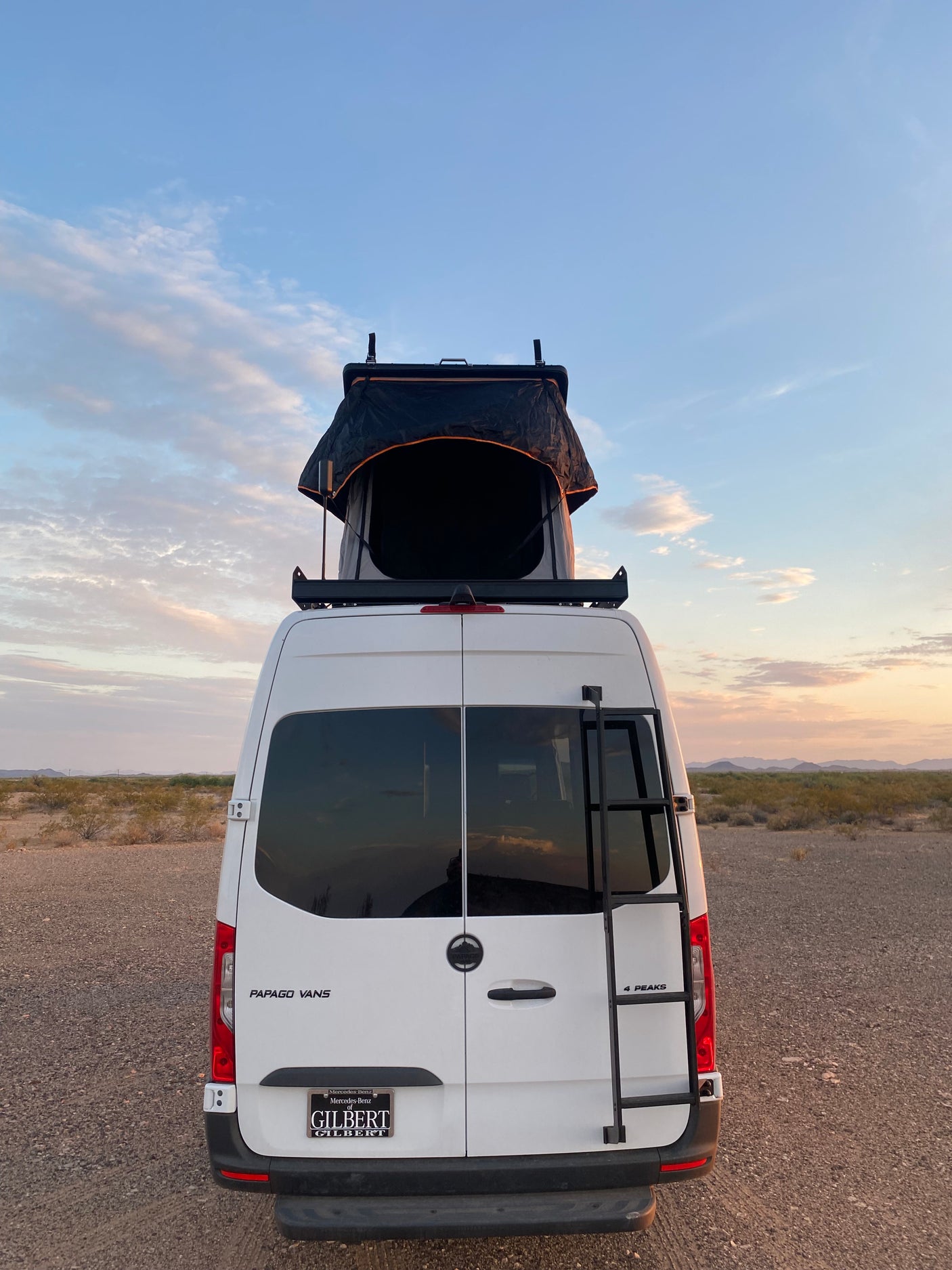 White Papago 4 Peaks camper van with rooftop tent in desert, ideal for an