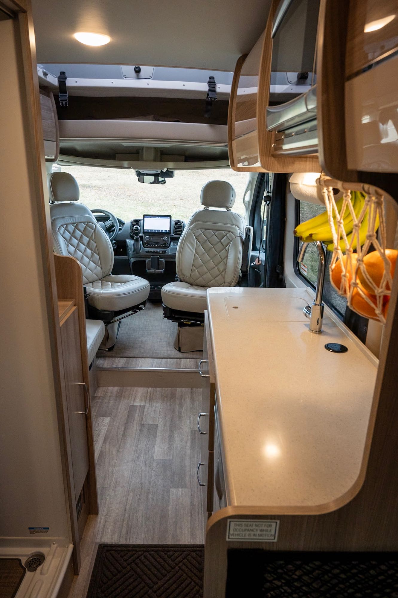 and a compact kitchen counter.|RV rental interior: Swivel seats — photo 13