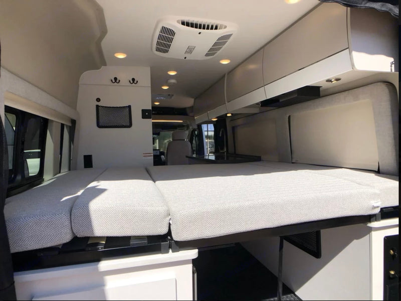  overlooking the front cabin.|This RV rental shows a versatile interior with a raised bed — photo 5