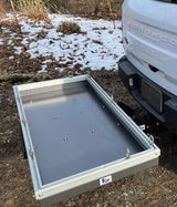 A sturdy hitch cargo carrier attached to a white Bronco Sport, providing extra gear space for RV rental adventures.