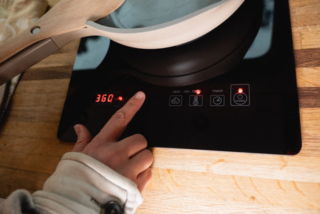 Cooking on a portable induction cooktop, set to 360 degrees, perfect for your RV rental kitchen.