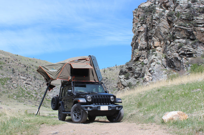 Adventure awaits! This black Jeep with a deployed rooftop tent, an alternative to an RV rental, is ready for off-road camping. — photo 15