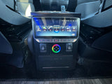 RV rental interior: touchscreen media panel with navigation, music, BT, and coach lighting controls for your journey.