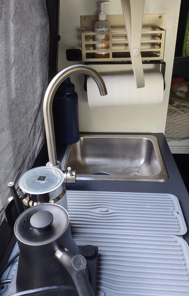RV rental kitchen showing sink, kettle, Nespresso frother, and drying mats. Compact and functional for road trips. — photo 8