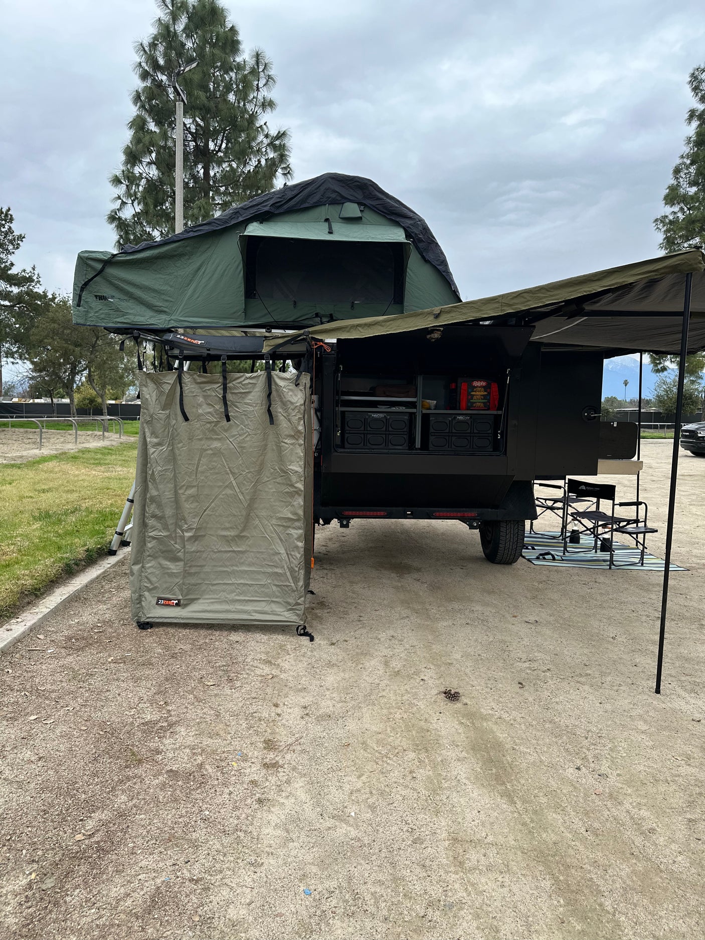 Experience outdoor living with this overland trailer, featuring a rooftop tent & privacy shower, great for RV rental or camping!