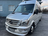 Front view of a silver Mercedes-Benz Sprinter RV rental, a modern and fully equipped camper van.
