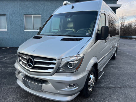 Front view of a silver Mercedes-Benz Sprinter RV rental, a modern and fully equipped camper van.