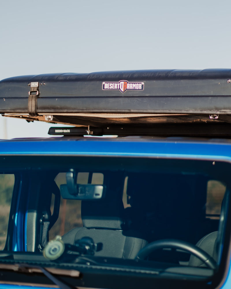 Blue vehicle with a Desert Armor roof-top tent and Rhino-Rack, ready for adventure. Ideal for an RV rental trip. — photo 8