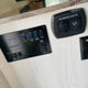 RV rental interior showing a control panel with switches & indicators for tanks/battery, and a charging center with USB/12V ports.