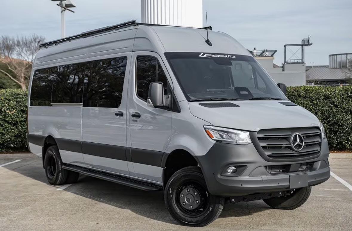 Gray Mercedes-Benz Sprinter camper van with roof rack & off-road tires
