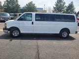 A white Chevy Express van, a common choice for rv rental fleets & group transport.