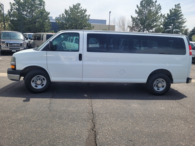 A white Chevy Express van, a common choice for rv rental fleets & group transport. — photo 12