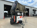 A robust off-road camping trailer, the Woolly Bear, with a 23ZERO rooftop tent, ideal for your next RV rental adventure.