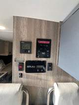 RV rental interior wall with essential controls: Truma heater, Winnebago systems, Xantrex solar, and tank heater.