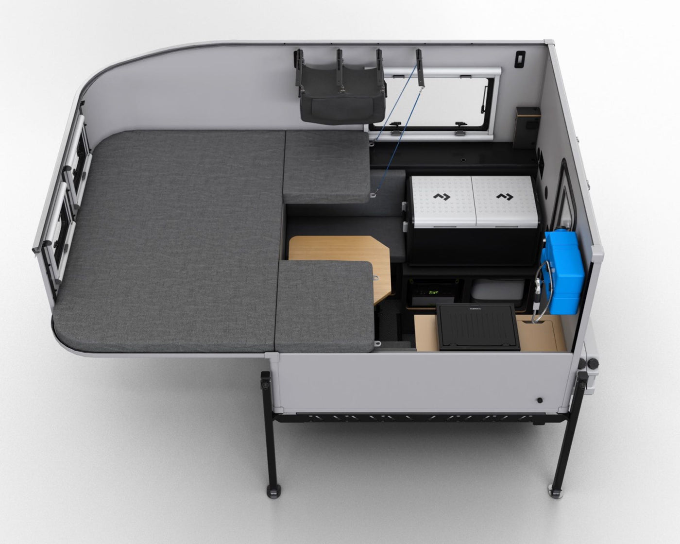 Aerial view of a modern RV rental interior, featuring modular bed/seating, a portable fridge, and a functional table. — photo 13