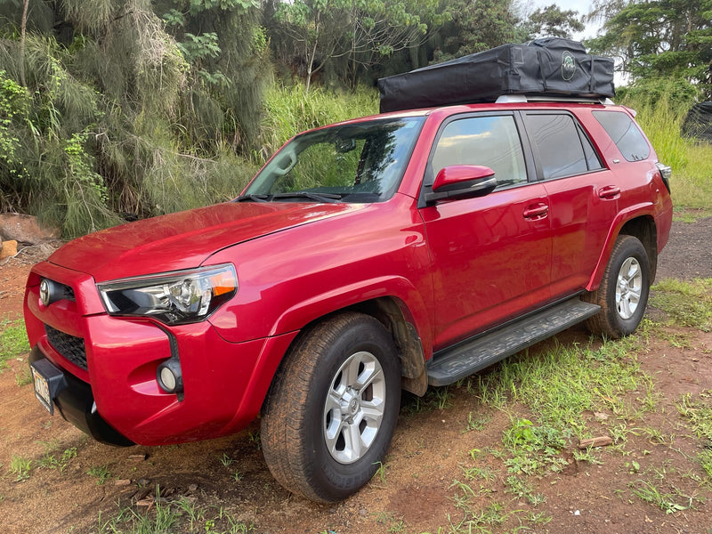Red Toyota 4Runner SUV with rooftop tent on a dirt path, ideal for your RV rental and adventure travel. — photo 11