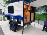 Ready for adventure: A Sunray Classic teardrop trailer RV rental with its rear kitchen open, perfect for outdoor cooking.