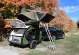 Explore nature with this RV rental: a green teardrop trailer with a 23 ZERO rooftop tent, perfect for autumn overlanding.