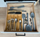 Organized kitchen drawer in an RV rental, featuring neatly arranged utensils, cutlery, and cooking tools for your trip.