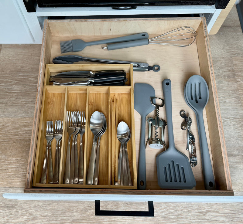 Organized kitchen drawer in an RV rental, featuring neatly arranged utensils, cutlery, and cooking tools for your trip. — photo 11