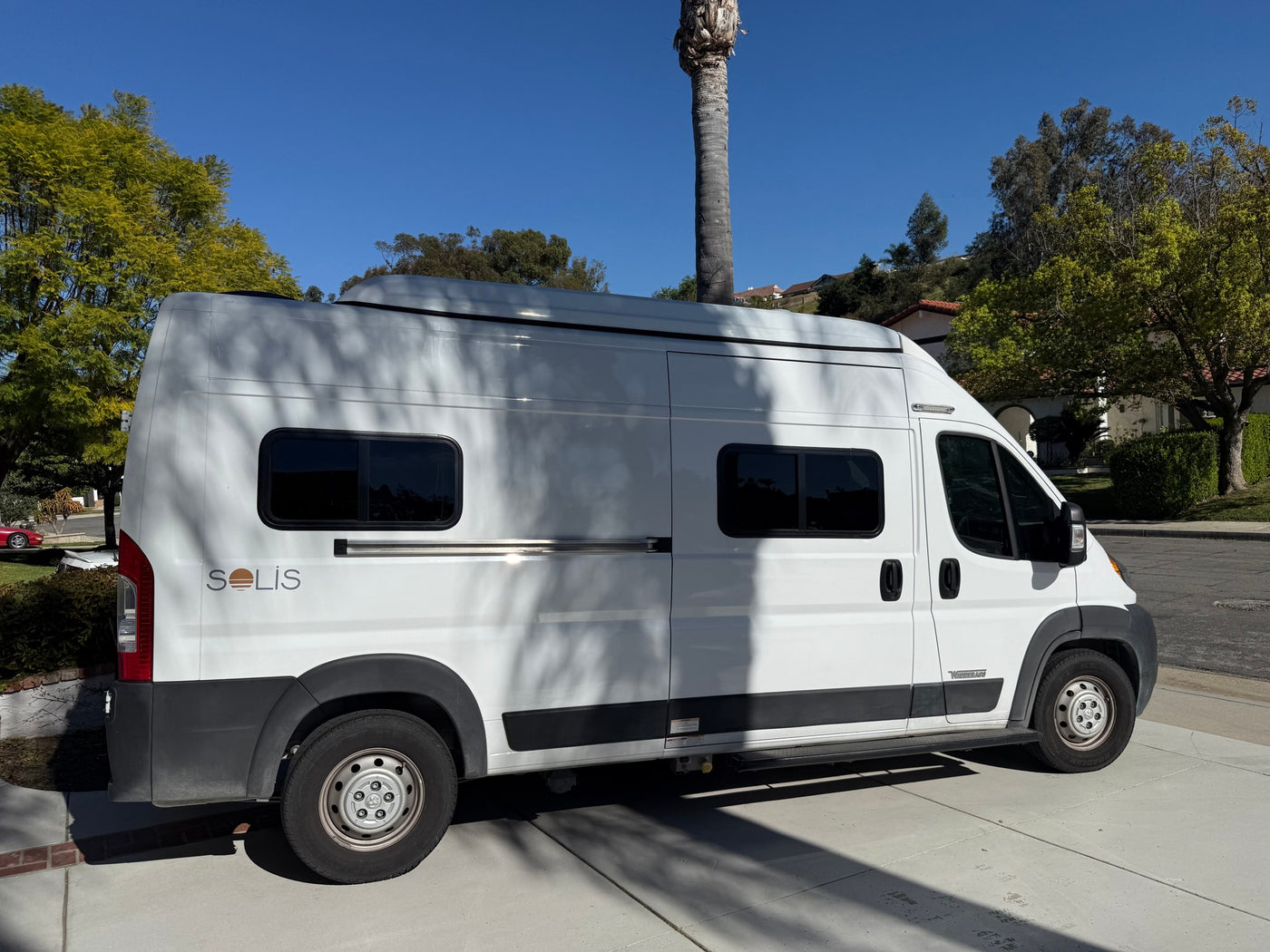  plugged in for charging at home.|A white Winnebago Solis camper van — photo 2