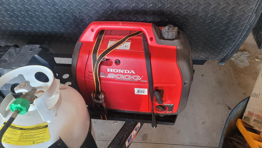 RV rental setup: Honda EU2000i generator and propane tank secured for travel, ready for adventure and off-grid power.