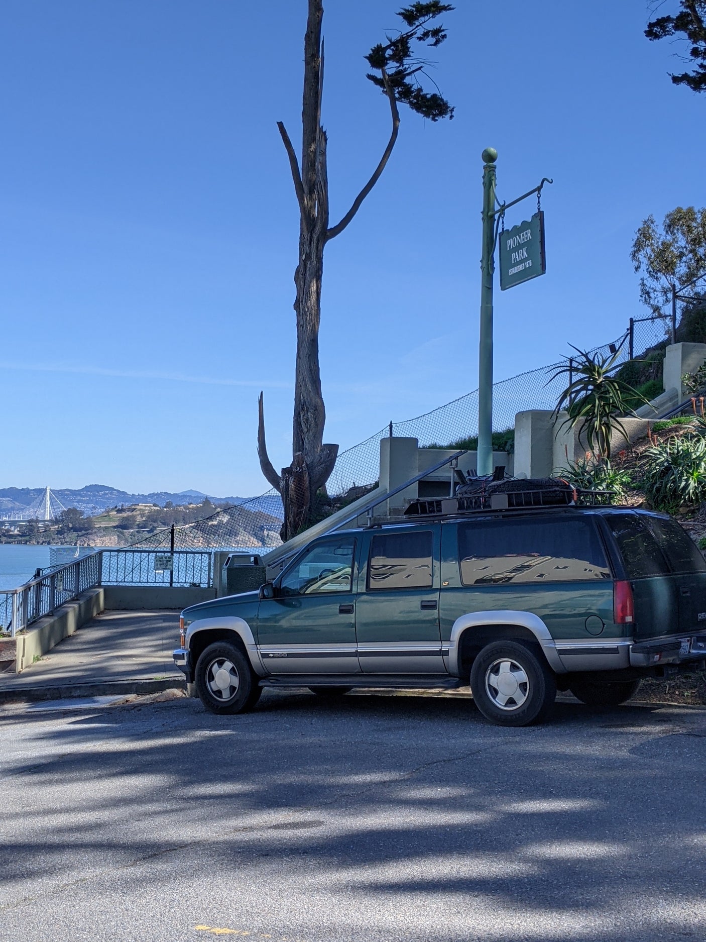 A green SUV at Pioneer Park with bay views. Though not an RV rental, it suggests road trip possibilities overlooking the water.