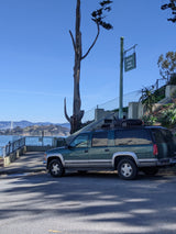 A green SUV at Pioneer Park with bay views. Though not an RV rental, it suggests road trip possibilities overlooking the water.