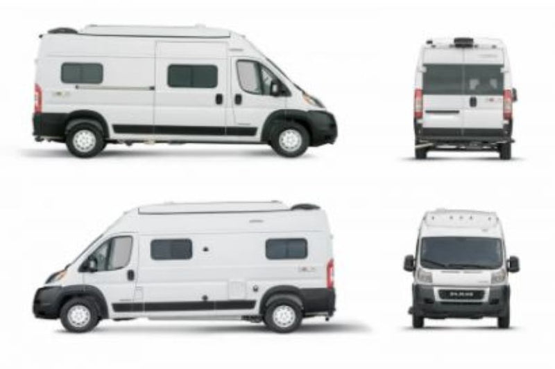  parked on grass in a wooded setting. Ideal for rv rental adventures.|A white Winnebago camper van — photo 2