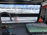 Cozy RV rental interior shows sink, stove, & a snowy vista with skis outside. Ideal for winter travel.