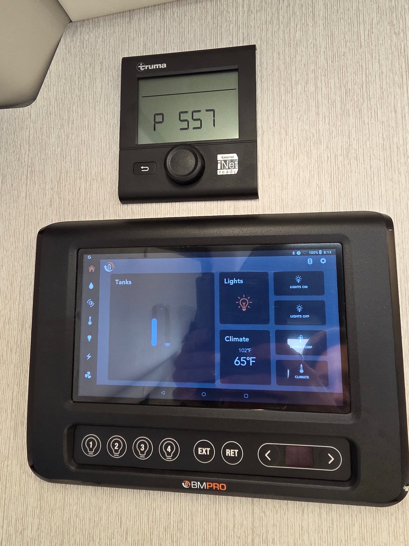 RV rental smart control: Truma thermostat (P 557) & BMPRO panel managing tanks, lights, and climate (102°F/65°F). — photo 14