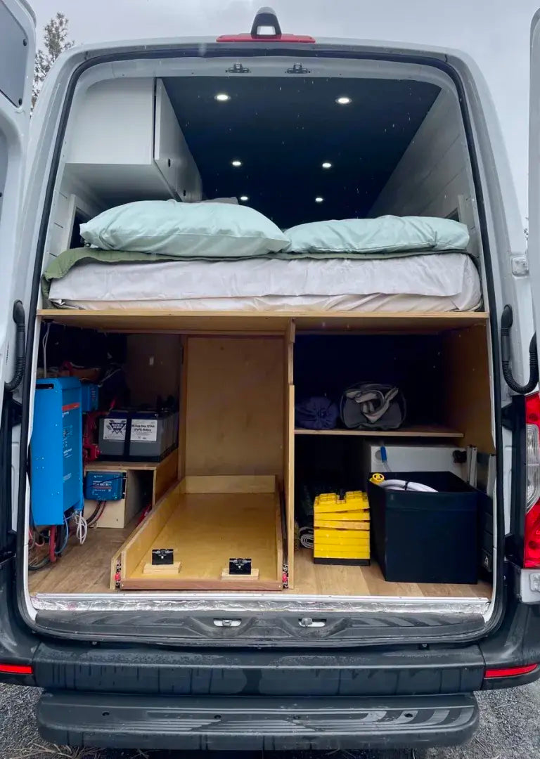  and front seats.|Discover this unique RV rental: a compact camper van interior with a teal kitchen — photo 8