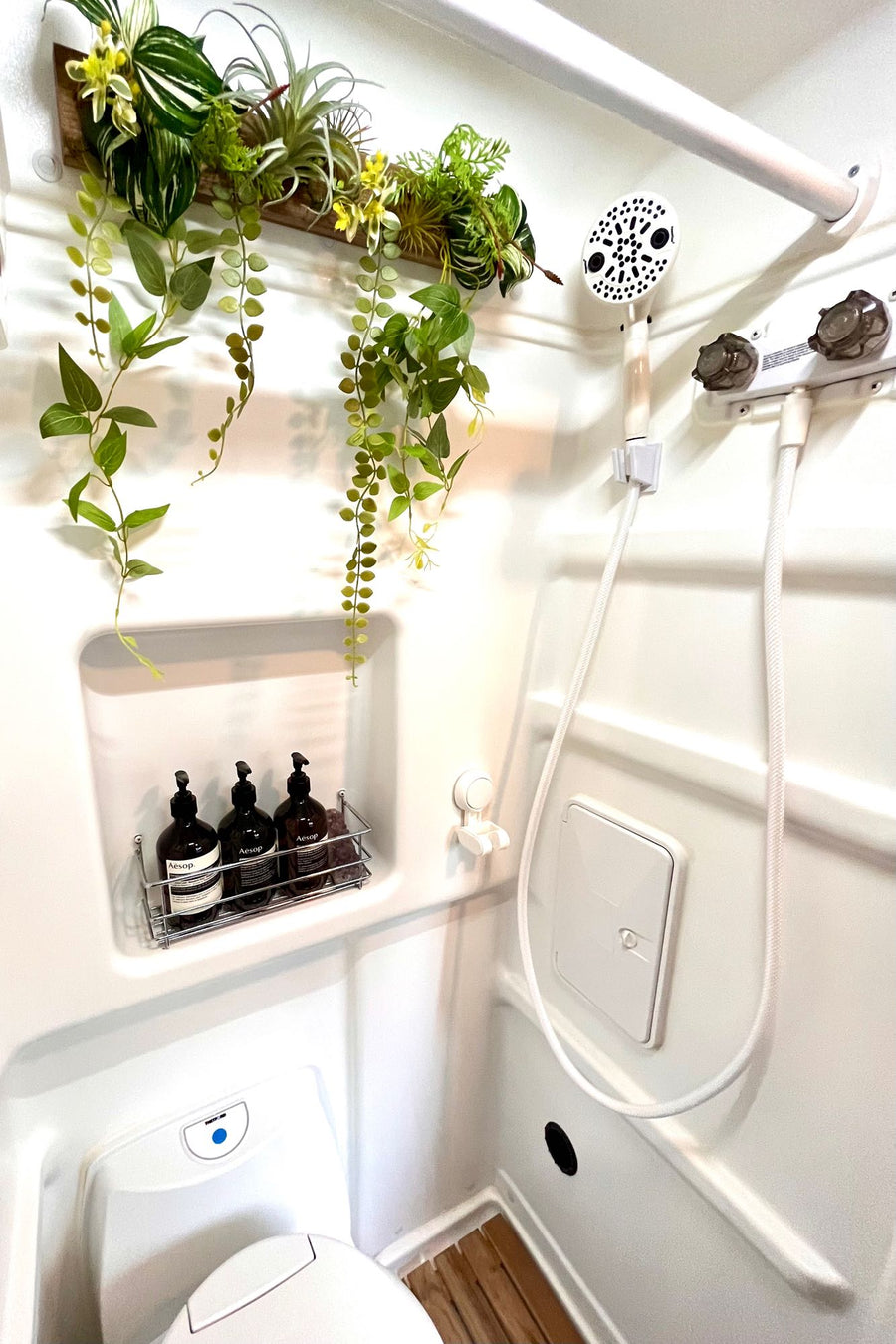  and AC vent.|Compact RV rental bathroom features a modern toilet