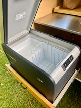  perfect for outdoor cooking in a rainy forest.|Compact galley kitchen in a teardrop RV rental with Dometic fridge