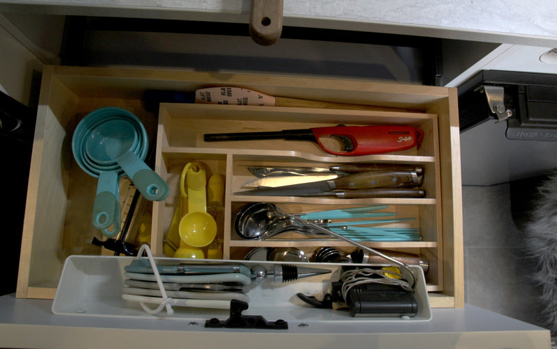  seen from a warm wooden doorway.|Inside a stylish RV rental: kitchenette with fresh produce — photo 15