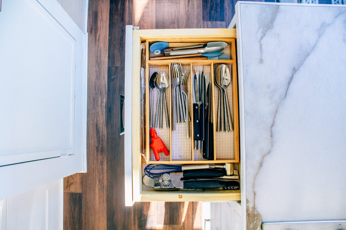 Organized RV rental kitchen drawer, neatly storing utensils and gadgets for compact, efficient use on your adventures.