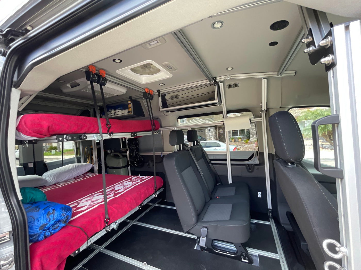 RV rental interior showcasing comfortable bunk beds, passenger seats, and a functional layout, perfect for road trips. — photo 10
