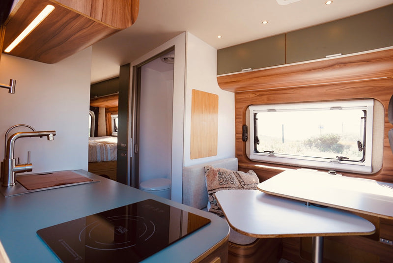  modern RV rental interior showing a kitchen with cooktop — photo 17