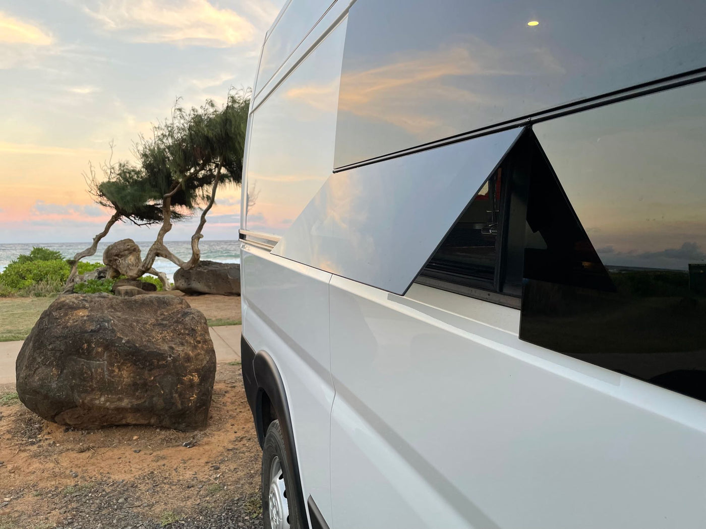  and a back window view of the beach.|Compact RV rental kitchen featuring green cabinets — photo 12