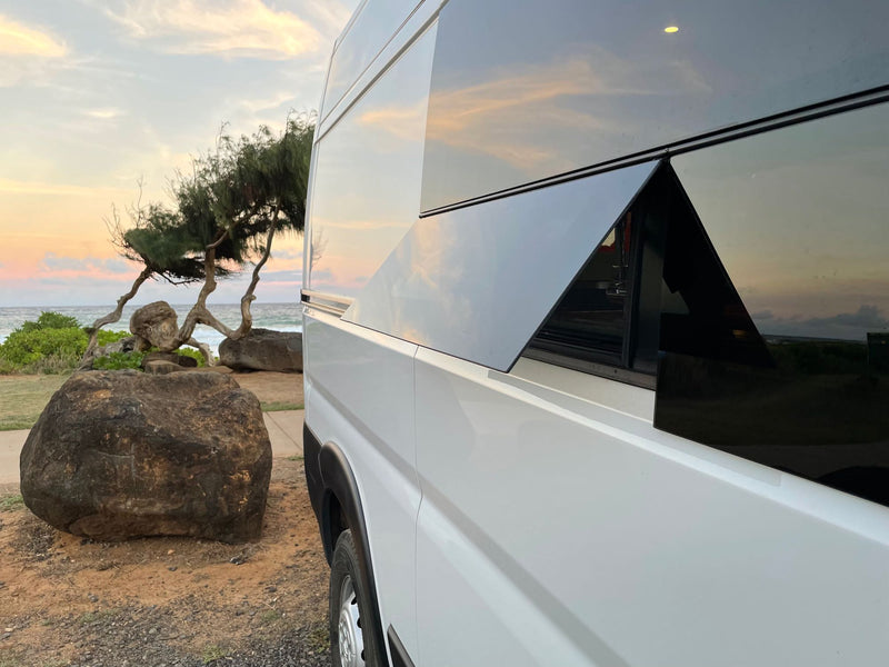  and a back window view of the beach.|Compact RV rental kitchen featuring green cabinets — photo 12