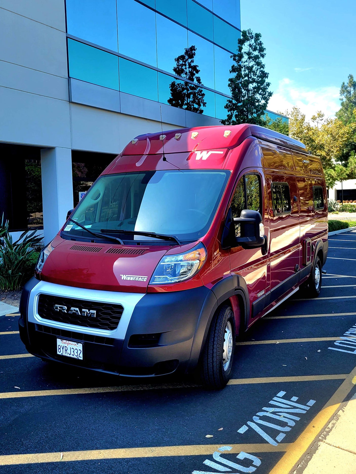 Explore in style with this red Winnebago ProMaster van, ideal for your next RV rental.