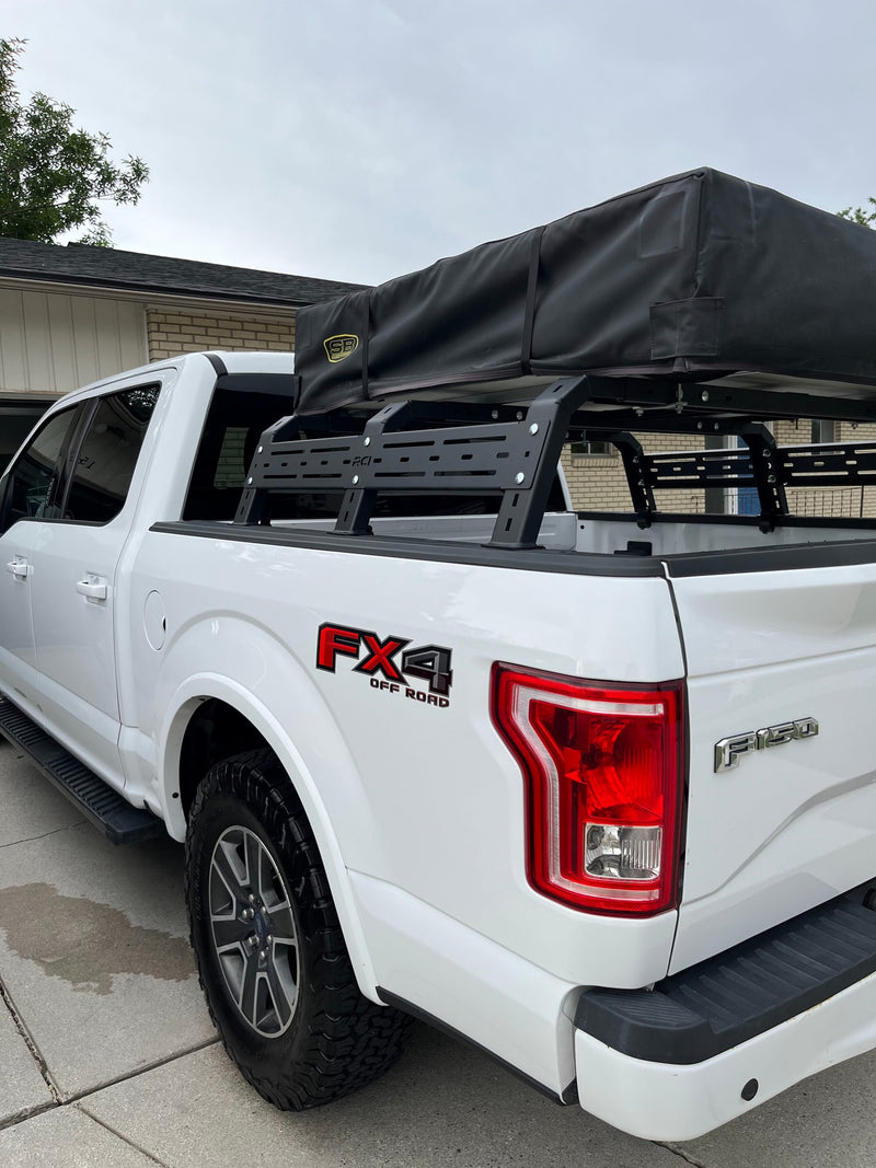 White Ford F-150 FX4 off-road truck with RCI bed rack and rooftop tent, perfect for camping or an RV rental adventure. — photo 20