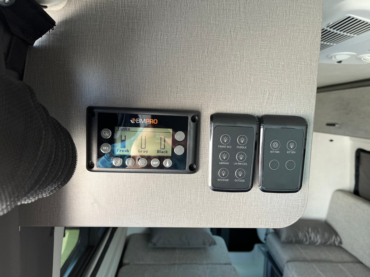  and utility hookups with safety warnings on the side.|RV rental: Rear view of a gray camper van's interior — photo 20