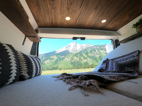 Experience serene van life! This cozy RV rental offers stunning mountain views from a comfortable interior. Perfect nature escape.