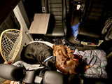Two dogs cozy and asleep in a spacious RV rental cabin, perfect for pet-friendly road trips.