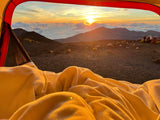 Cozy tent view of a stunning mountain sunrise with fellow campers. Ideal for an RV rental adventure!